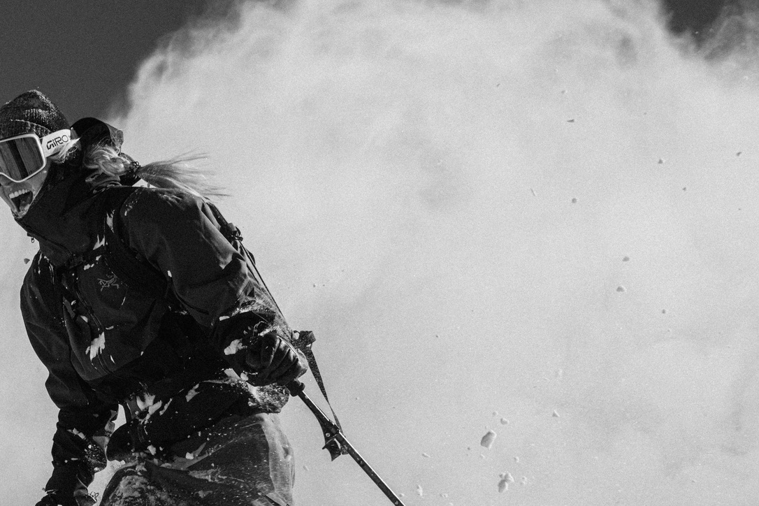 Skier moving through blowing snow during the Arc’teryx ABA Hero photography campaign