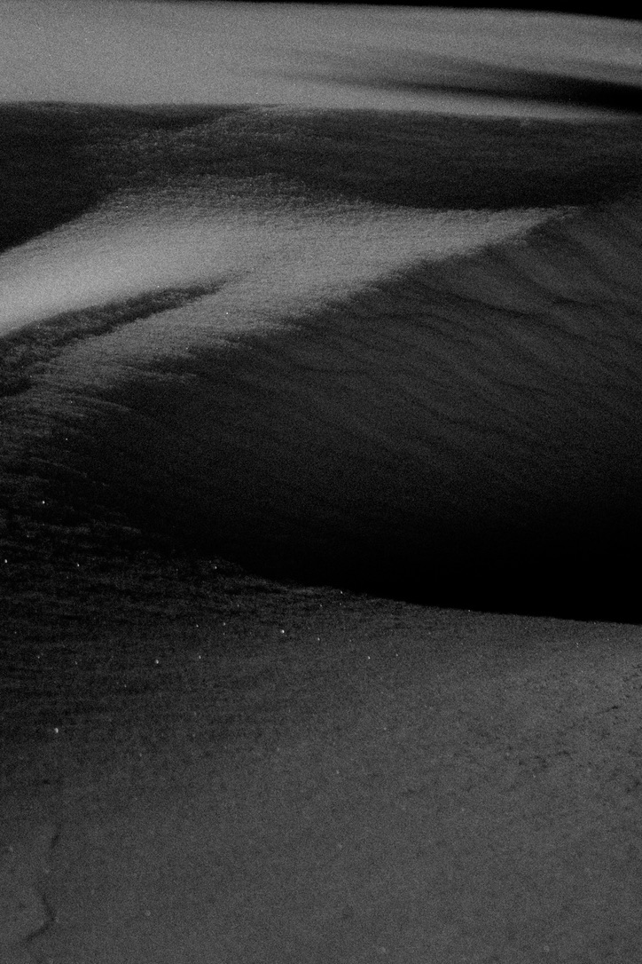 Black-and-white abstract detail of wind-shaped snow from the Arc’teryx ABA Hero campaign